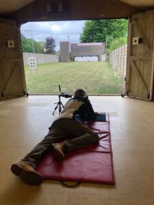 A shooter firing from the fifty metre firing point in the new training building