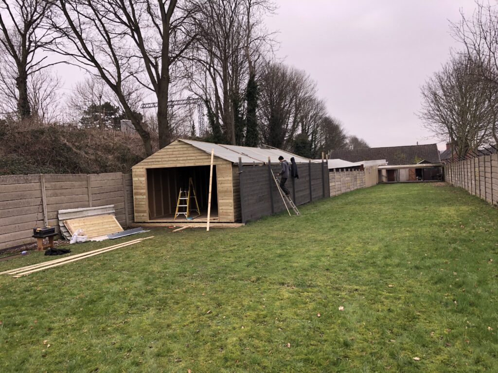 A prefabricated wooden building being constructed.