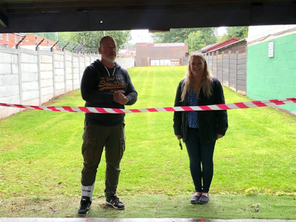 Club Chairman Martyn Buttery & local Councillor Olivia Lyons stand in front of a tape as they formally open the new range wall.
