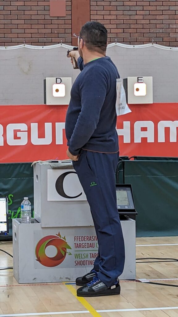 A man aims an air pistol during a final at the Welsh Airgun Championships.