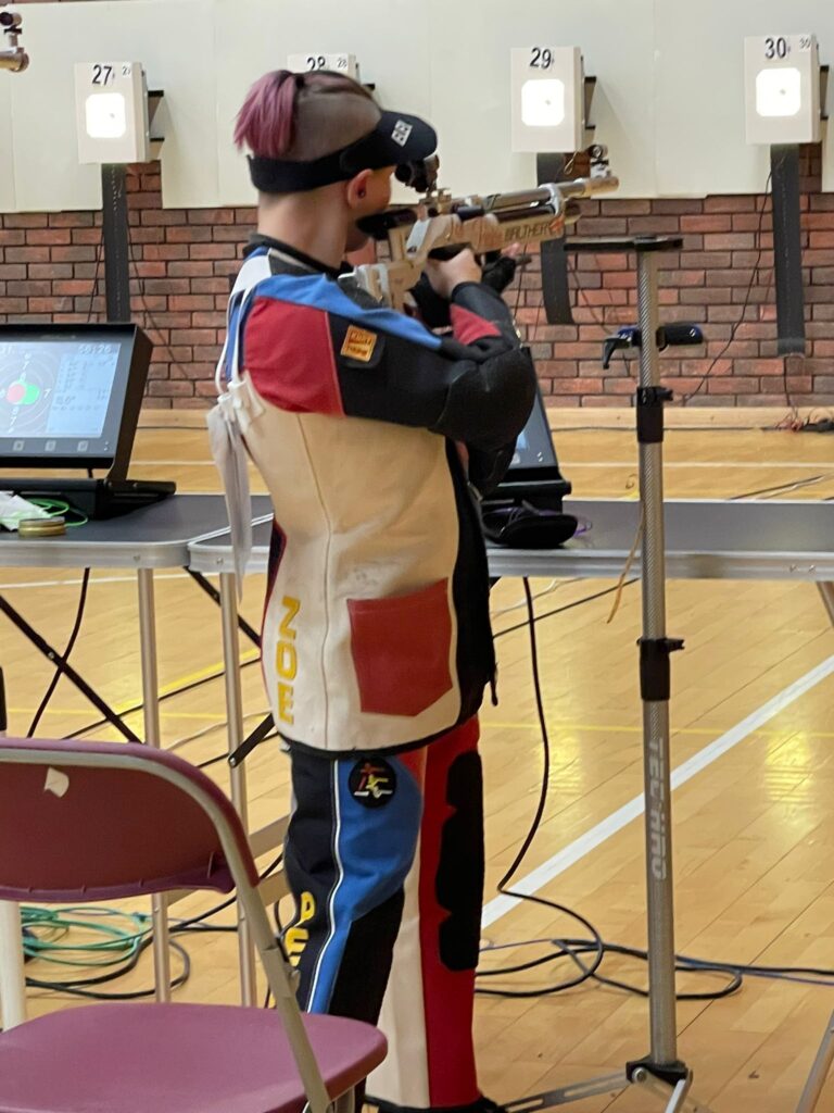 A young lady aims an air rifle at the Welsh Airgun Championships