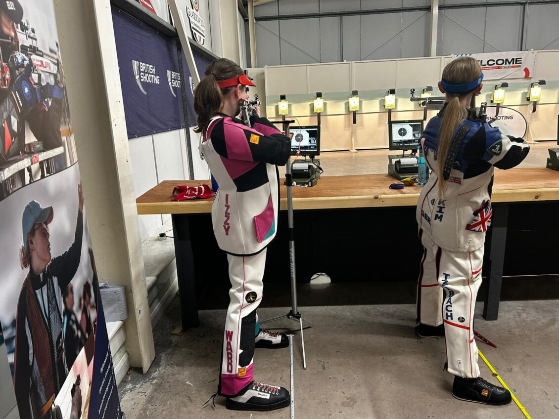 A young athlete aims a target air rifle at a 10metre electronic target in competition