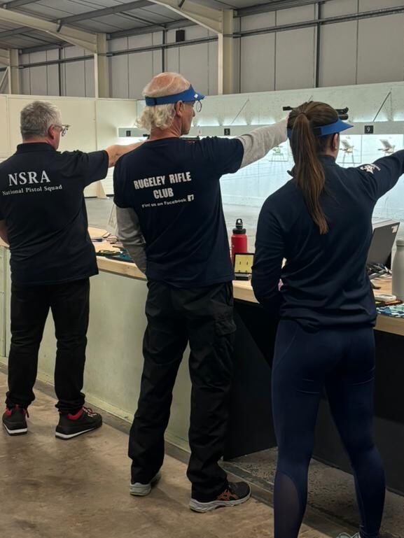 Athletes fire target air pistols in an Olympic Final style match at the Aldersley Leisure Village