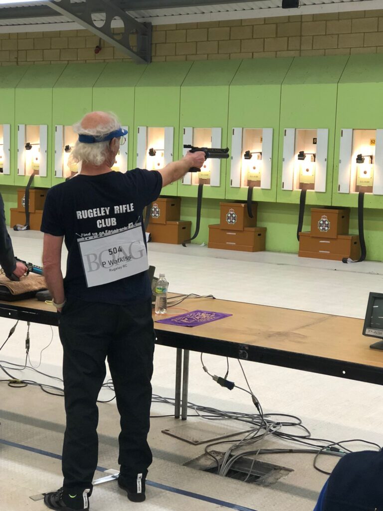 A man aims a target air pistol at the British Open Airgun Championships.